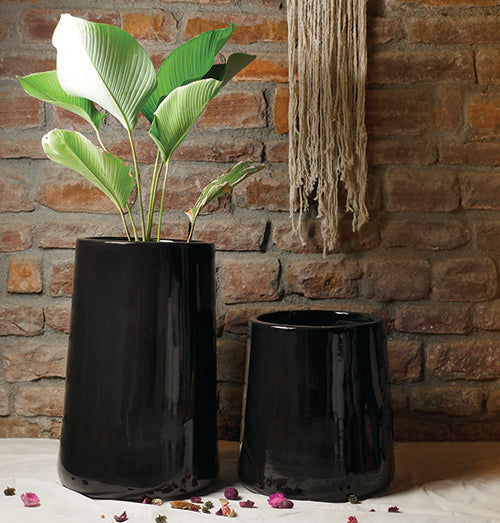 Tall size Misplaced Metaphor in black color with Plant and Large size Misplaced Metaphor Ceramic extra large planter are placed together.